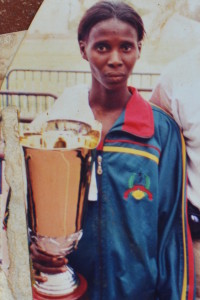 Domingas erguendo a taça de ouro ganha em Dakar